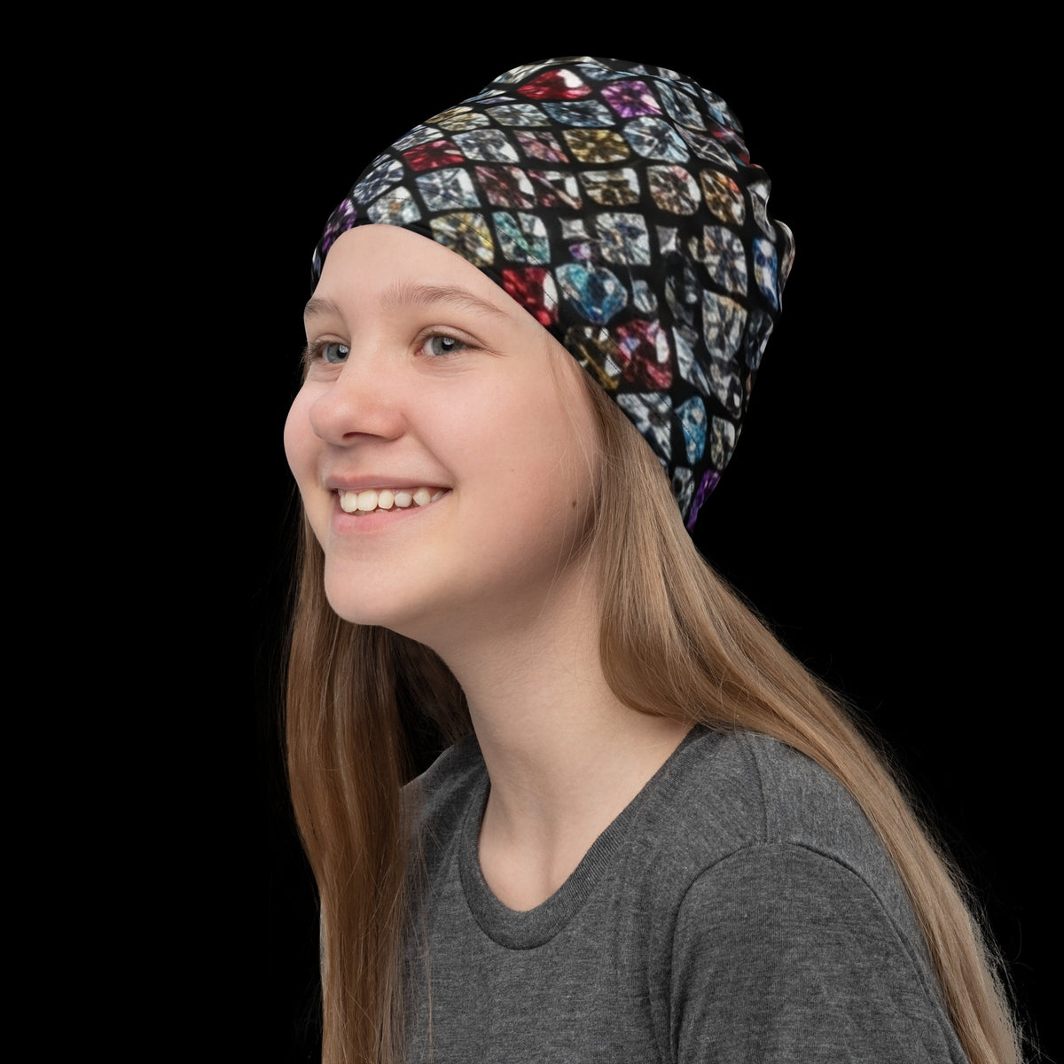 Street Culture neck gaiter with a colorful diamond pattern worn as a headband by a smiling girl on a black background