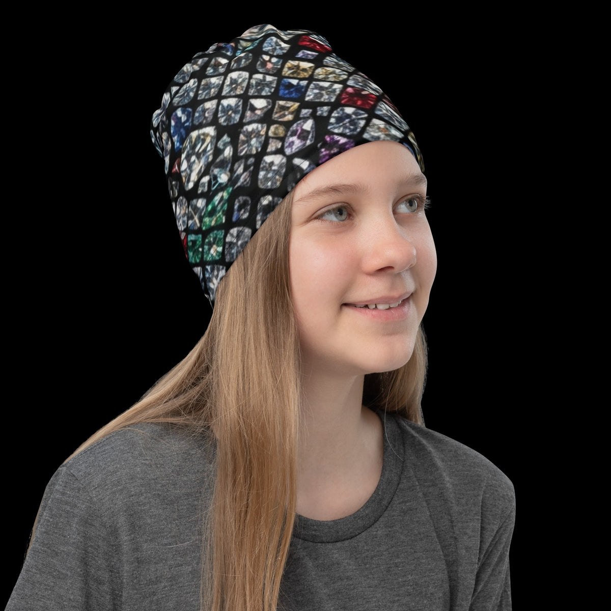 Street Culture neck gaiter with a colorful diamond mosaic print worn as a beanie by a young girl on a black background