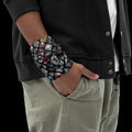 Street Culture neck gaiter worn as a wristband featuring a colorful diamond pattern on breathable stretch fabric