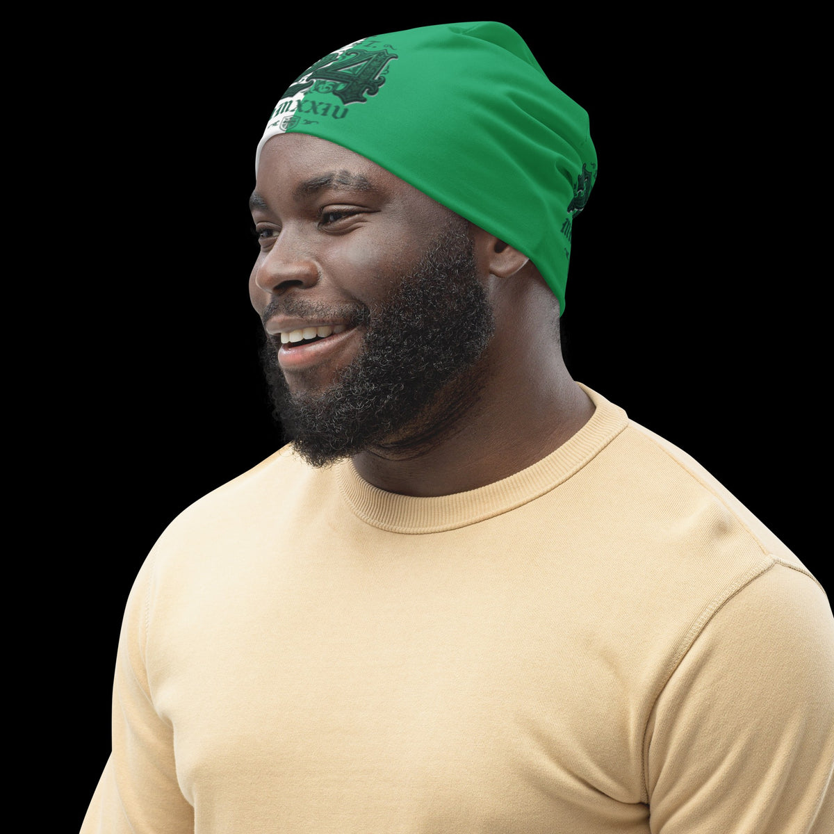 Street Culture beanie with green all-over print worn by a smiling man in a beige sweater against a black background