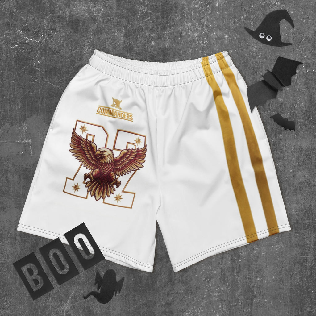 Street Culture white athletic shorts with eagle graphic, gold side stripes, and elastic waistband on grey background.