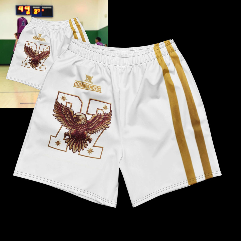 Street Culture white athletic shorts with eagle graphic, gold side stripes, and elastic waistband on stone background.